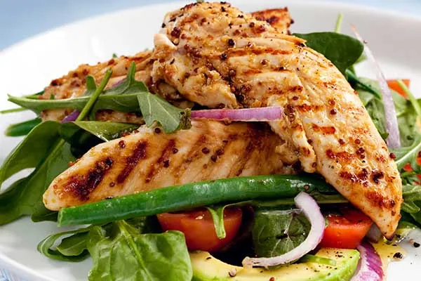 Grilled chicken on greens