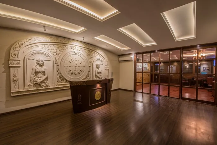The Texas Tower reception with a carved stone wall and the Texas Tower emblem
