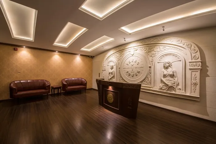Entrance lobby with a carved Texas Tower emblem wall and reception desk — Texas Tower, Kharadi